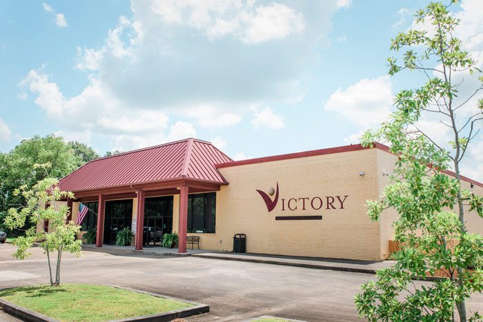 building exterior with American flag and benches - Victory Addiction Recovery Center - Lafayette addiction recovery center