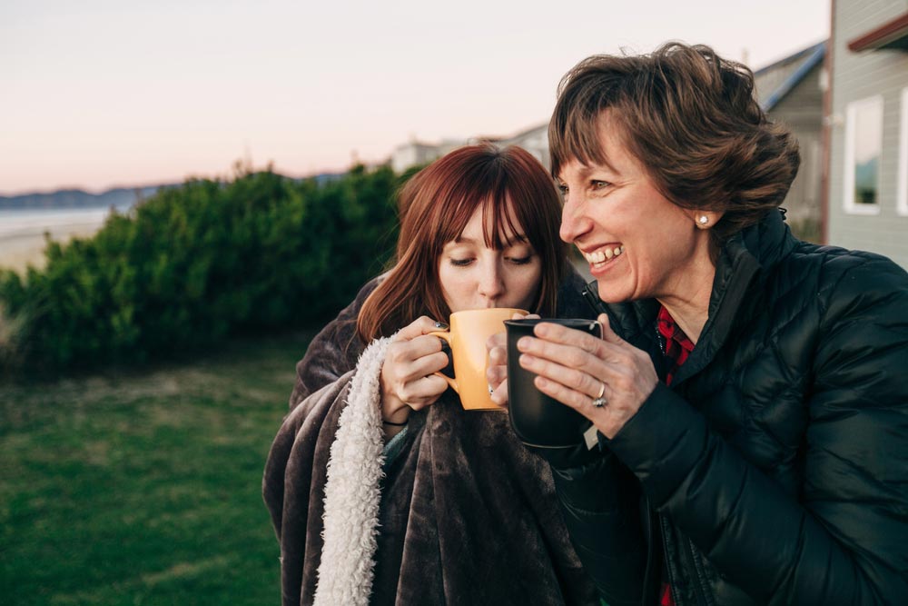 happy mother and daughter drinking coffee - benefits of sober monitoring - victory addiction recovery center - lafayette louisiana drug rehab center - addiction treatment and detox services