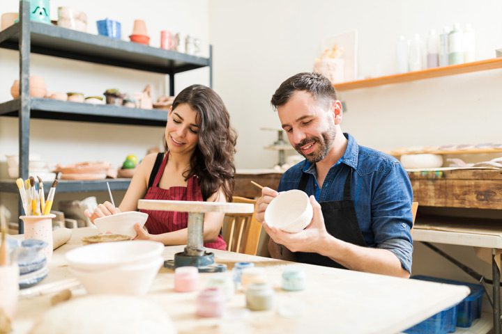 couple painting bowls at pottery class - sober dating